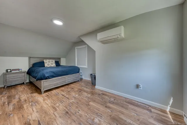 a bedroom with a bed and window