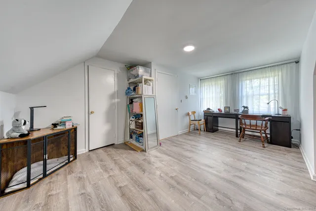 a view of a livingroom with wooden floor and furniture