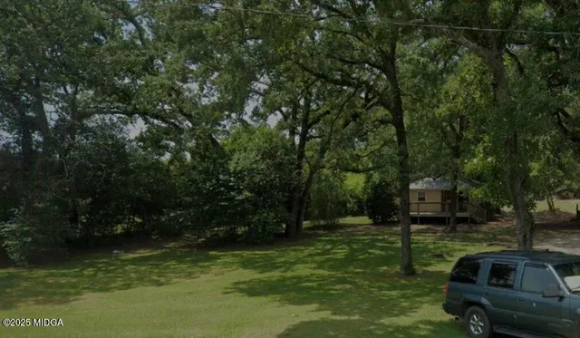 a view of backyard with swimming pool