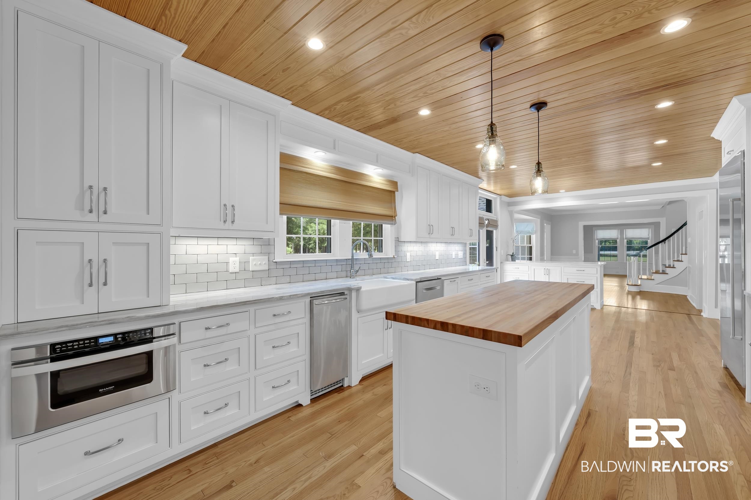 43199 Pine Grove Road Bay Minette, AL 36507 - Photo 41 of 71 Kitchen featuring a wood-finish plank ceiling, shaker-style white cabinetry, light countertops, subway tile backsplash, and wood-finish flooring