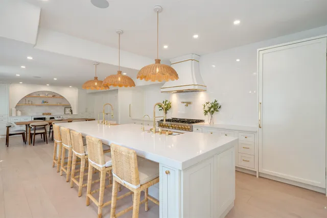 a large kitchen with a table and chairs