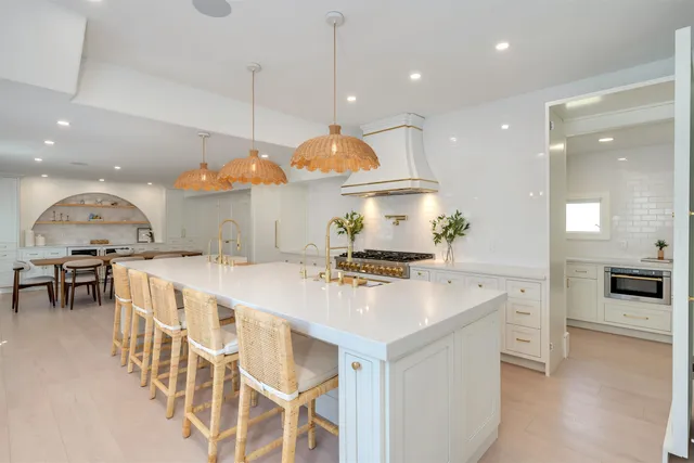 a large kitchen with a table and chairs