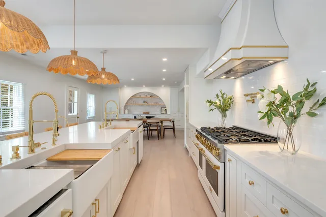 a open kitchen with stainless steel appliances granite countertop a sink a stove and a wooden floors
