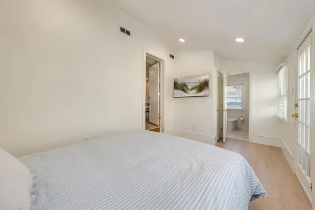 a spacious bathroom with a granite countertop sink a toilet and shower
