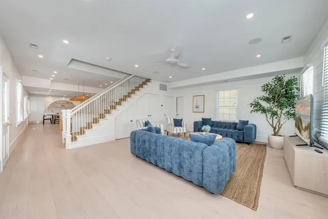 a living room with furniture and a potted plant
