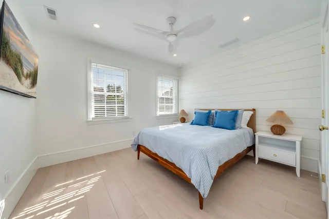a large bed sitting in a bedroom next to a window