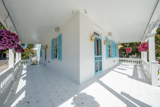 an aerial view of a house with swimming pool and large trees