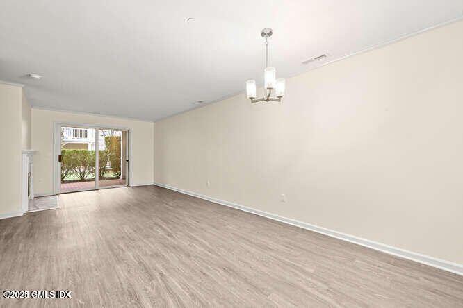 51 Forest Avenue, Unit 147 Old Greenwich, CT 06870 - Photo 2 of 19 a view of empty room with wooden floor and window