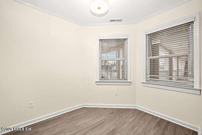 51 Forest Avenue, Unit 147 Old Greenwich, CT 06870 - Photo 5 of 19 an empty room with wooden floor and windows