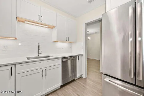 a kitchen with stainless steel appliances a sink and cabinets
