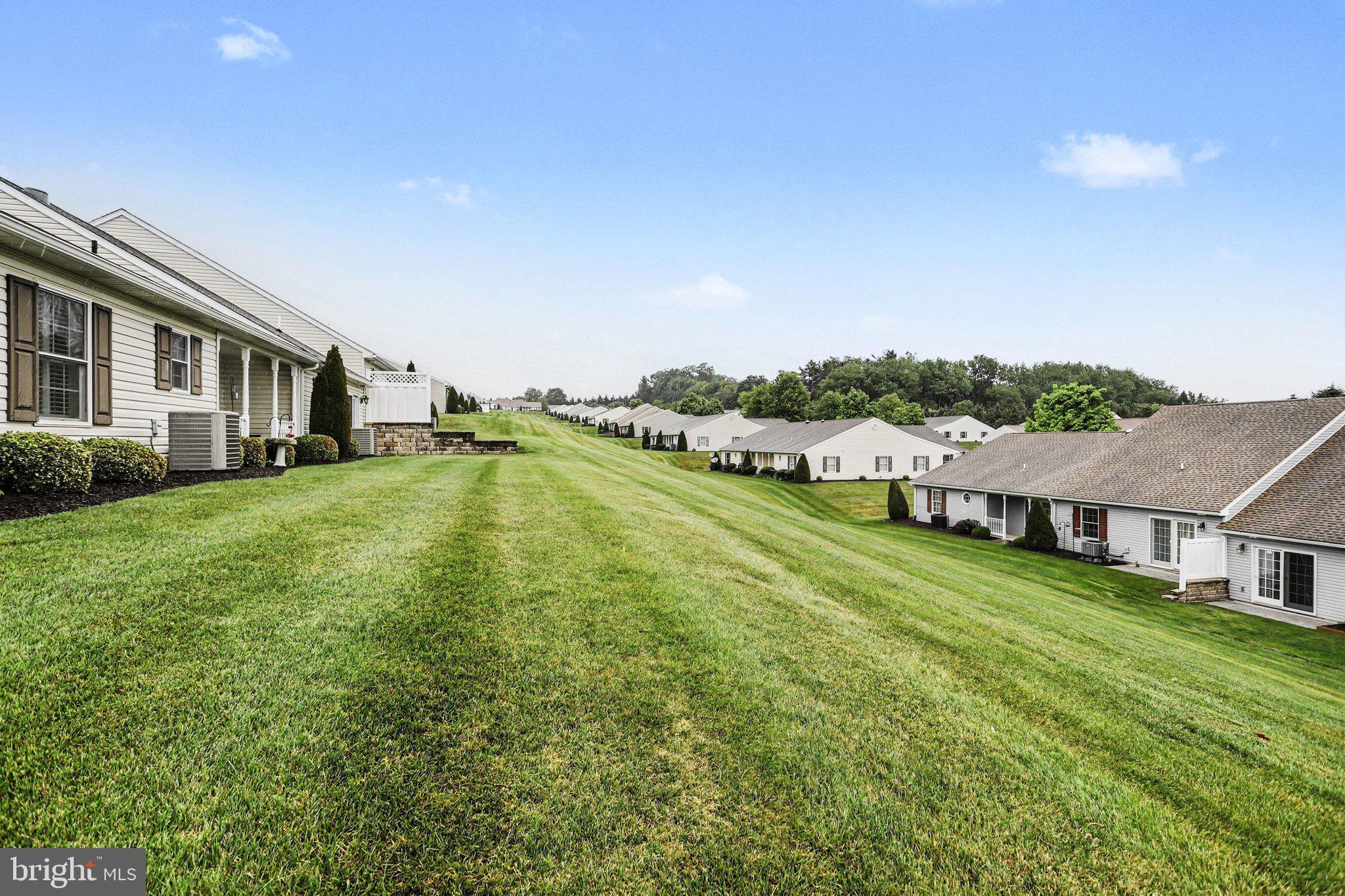 1371 Chami Drive, Unit 166 Spring Grove, PA 17362 - Photo 28 of 28 a view of a house with a big yard and large trees