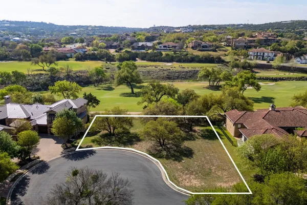 an aerial view of houses with a swimming pool