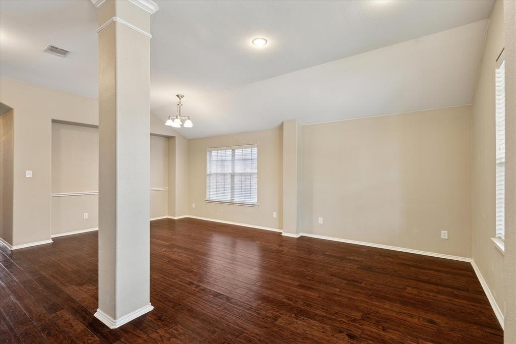 9308 Comanche Ridge Drive Fort Worth, TX 76131 - Photo 3 of 15 an empty room with wooden floor and windows