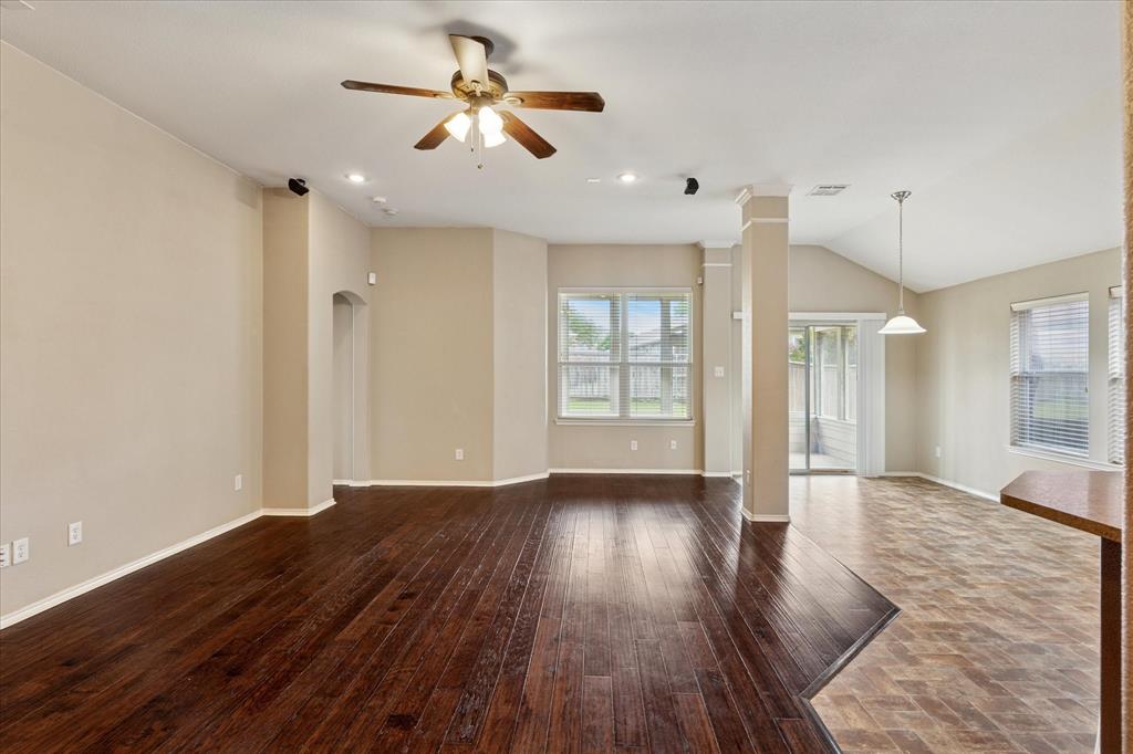 9308 Comanche Ridge Drive Fort Worth, TX 76131 - Photo 4 of 15 an empty room with wooden floor and windows
