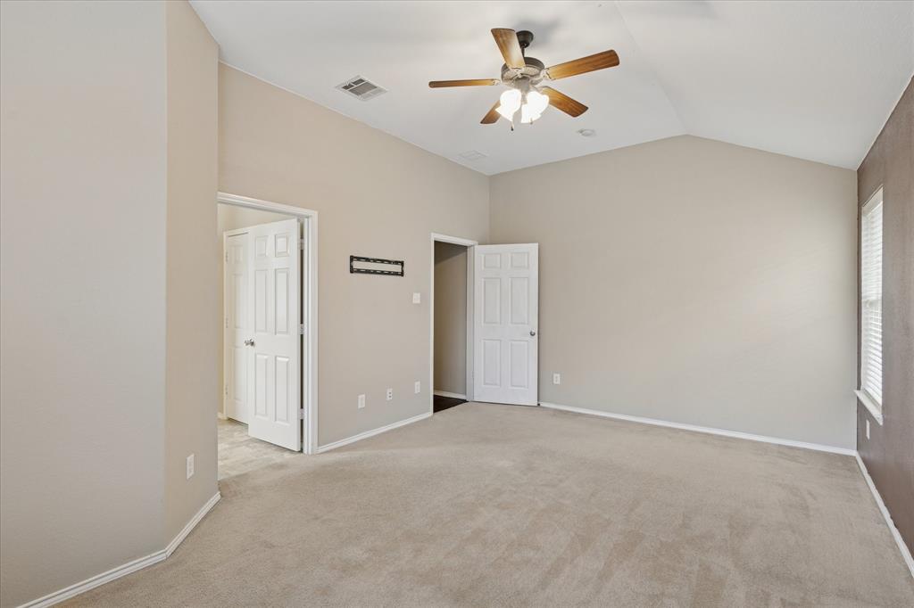 9308 Comanche Ridge Drive Fort Worth, TX 76131 - Photo 9 of 15 an empty room with closet and a chandelier fan