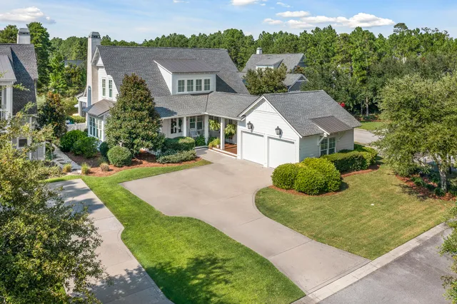 an aerial view of house with yard and lake view