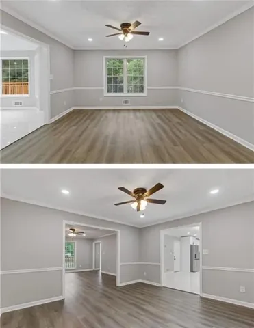 a view of an empty room with a window and wooden floor