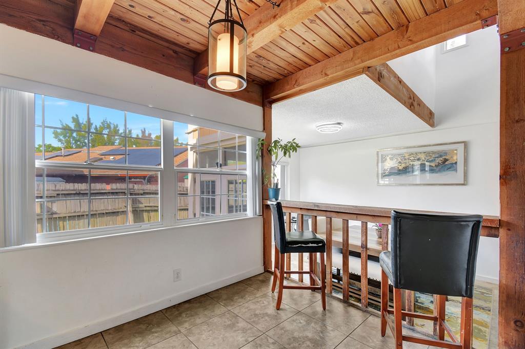 2420 Southwest 80th Terrace Miramar, FL 33025 - Photo 11 of 30 a view of a room with furniture large windows and a chandelier