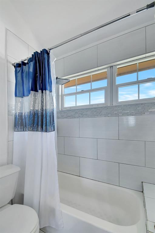 2420 Southwest 80th Terrace Miramar, FL 33025 - Photo 16 of 30 a bathroom with a toilet and a bathtub