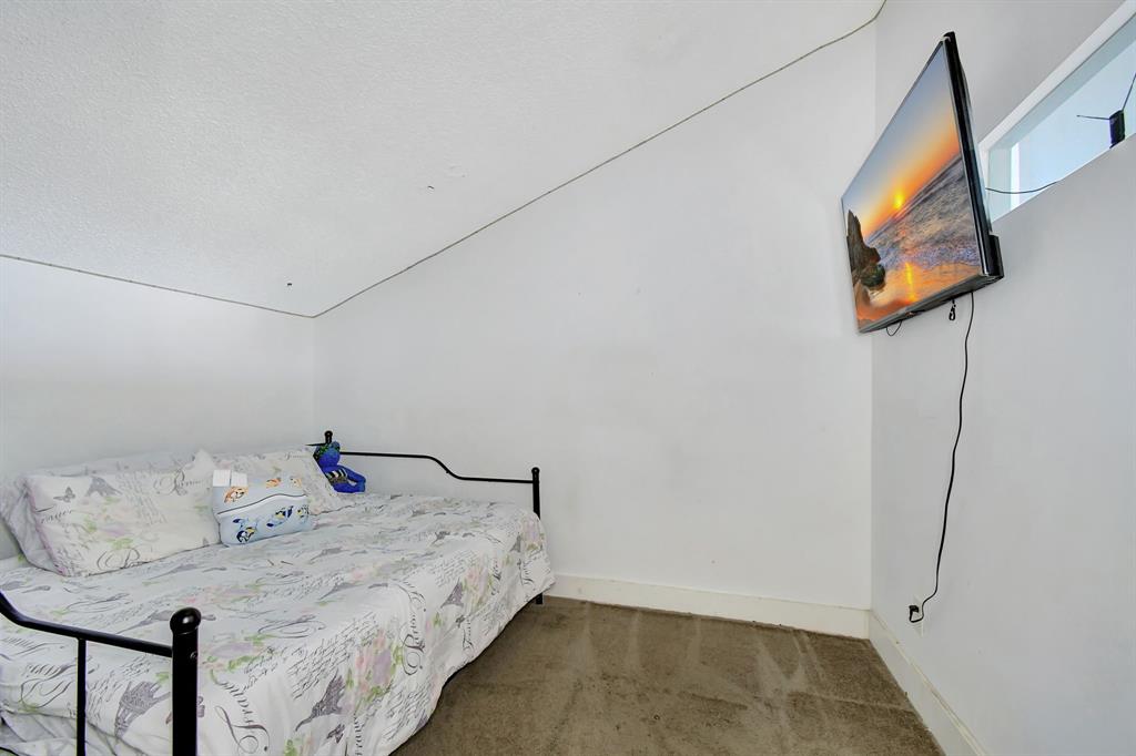 2420 Southwest 80th Terrace Miramar, FL 33025 - Photo 20 of 30 a bed sitting in a bedroom next to a cabinet