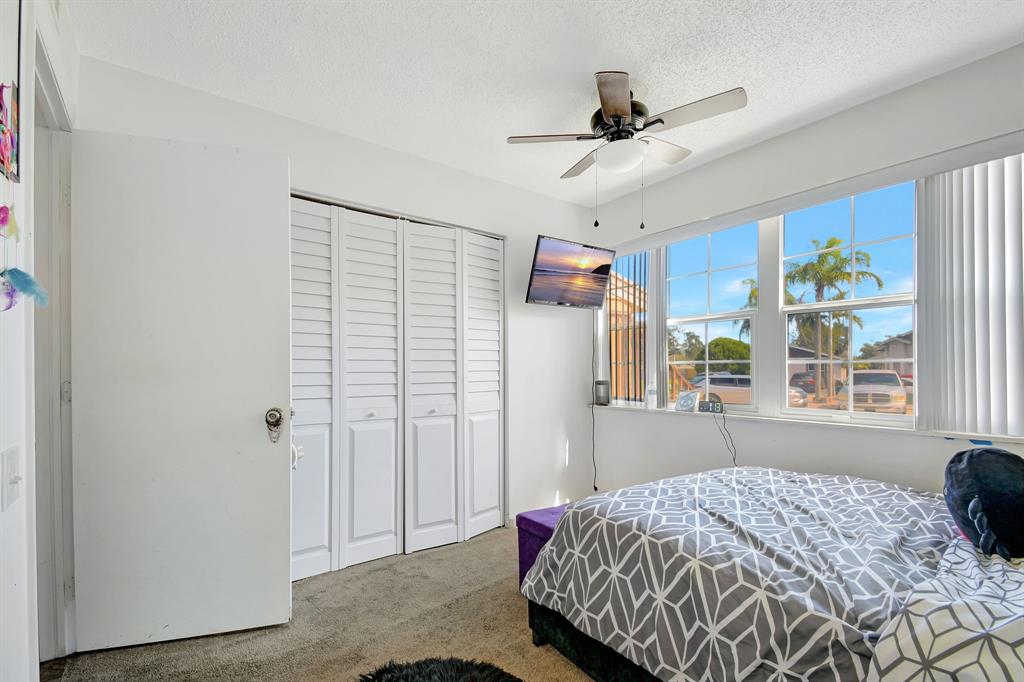 2420 Southwest 80th Terrace Miramar, FL 33025 - Photo 23 of 30 a bedroom with a bed and a window