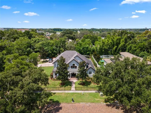 a view of a house with swimming pool and sitting area