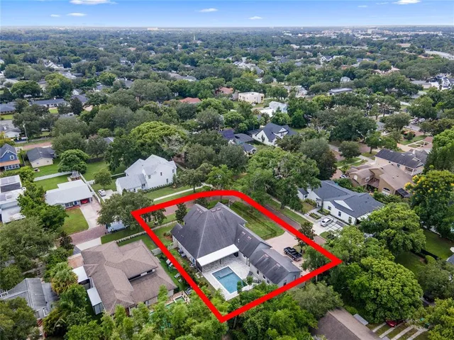 a kitchen with stainless steel appliances kitchen island granite countertop a dining table chairs and a refrigerator