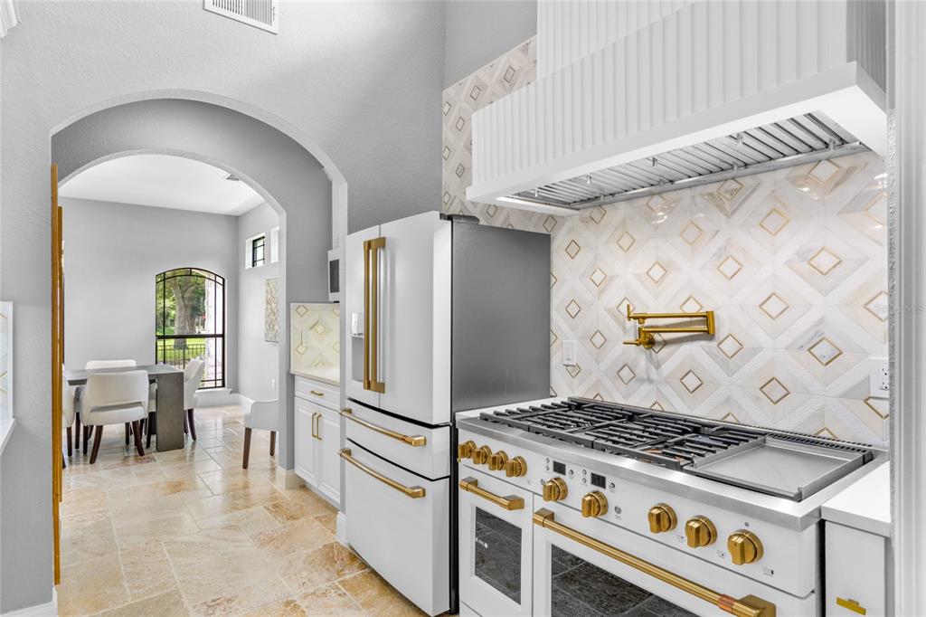 1451 Lyndale Boulevard Winter Park, FL 32789 - Photo 36 of 89 a kitchen with granite countertop a stove a refrigerator and a dining table