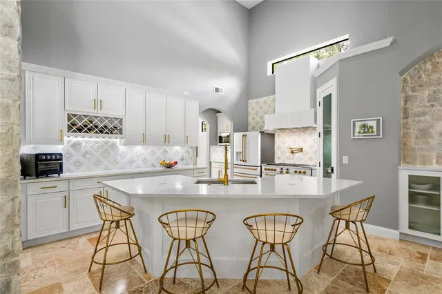 a bathroom with a granite countertop sink a toilet a mirror a vanity and shower