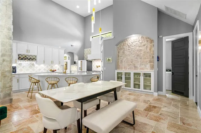 a kitchen with granite countertop a sink and a refrigerator