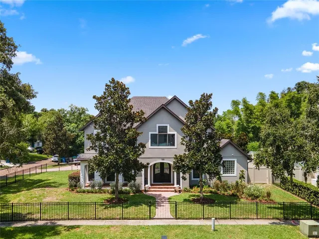a front view of a house with a garden and yard