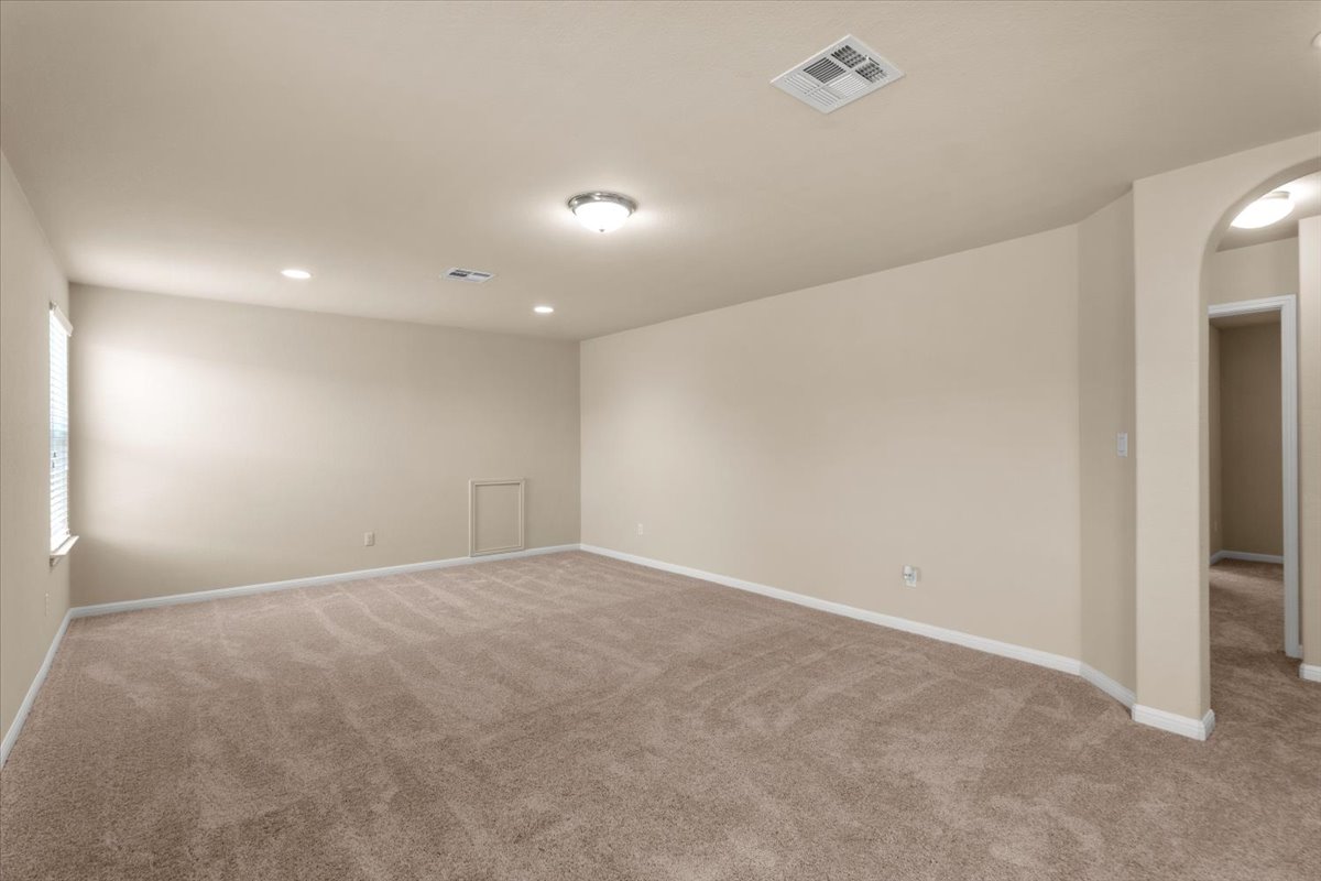 3451 Mayfield Ranch Boulevard, Unit 311 Round Rock, TX 78681 - Photo 23 of 40 Spacious room featuring neutral carpeting, light-toned walls, and white baseboards