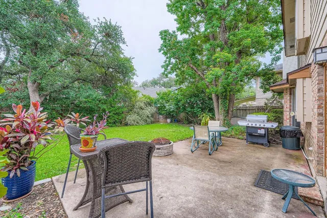 a view of a chairs and table in backyard of the house