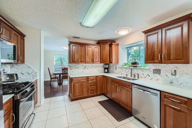 a kitchen with a sink stove and cabinets
