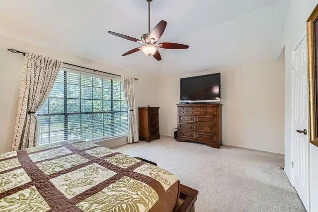 a bedroom with a bed and a television