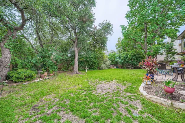 a view of a backyard with sitting area