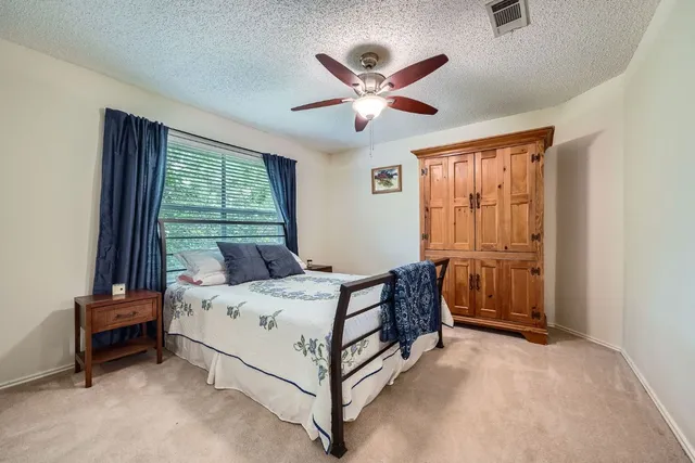 a bed sitting in a bedroom next to a window