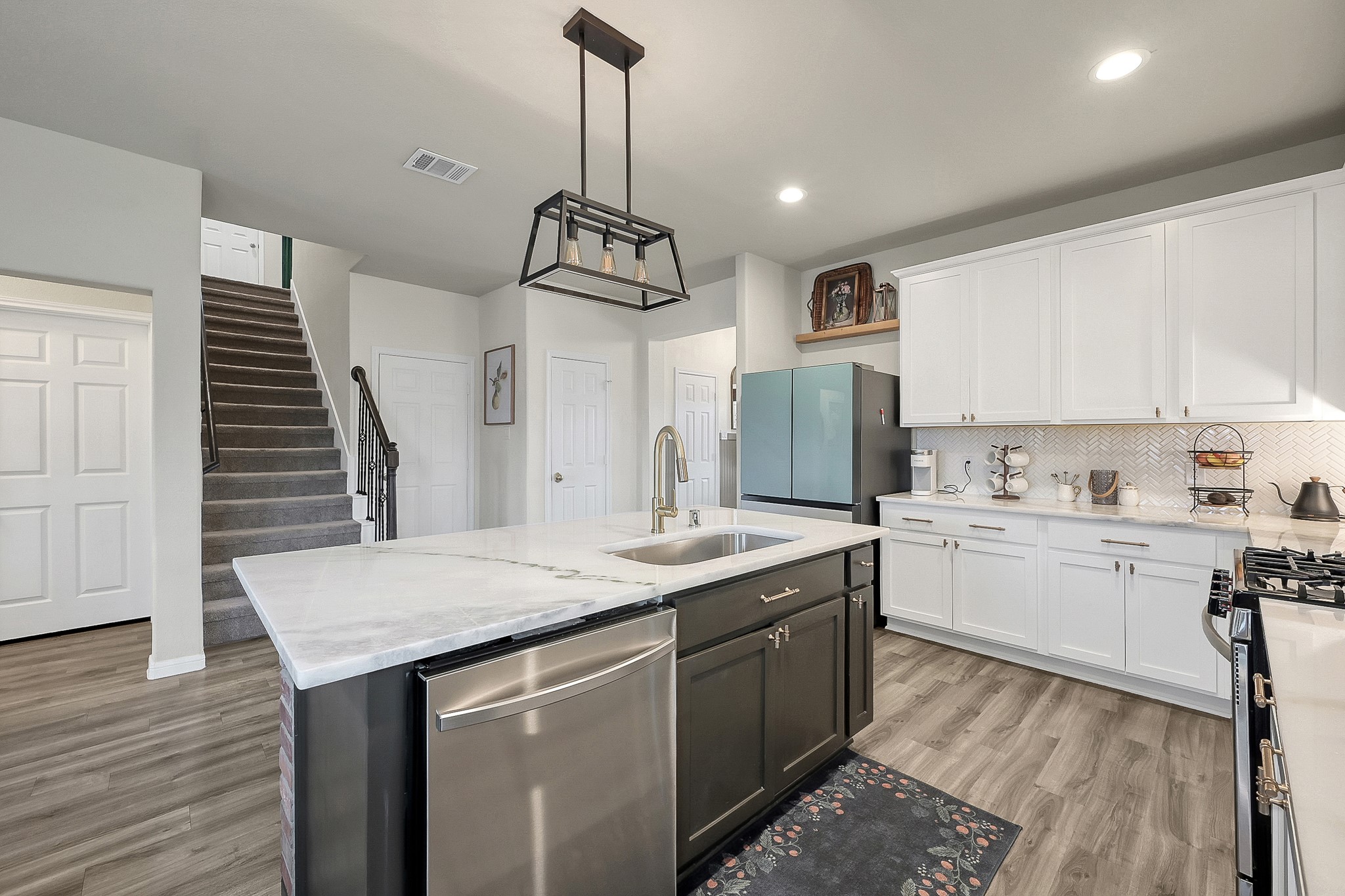 679 Red Elm Lane Conroe, TX 77304 - Photo 11 of 45 a kitchen with stainless steel appliances granite countertop a sink stove and refrigerator