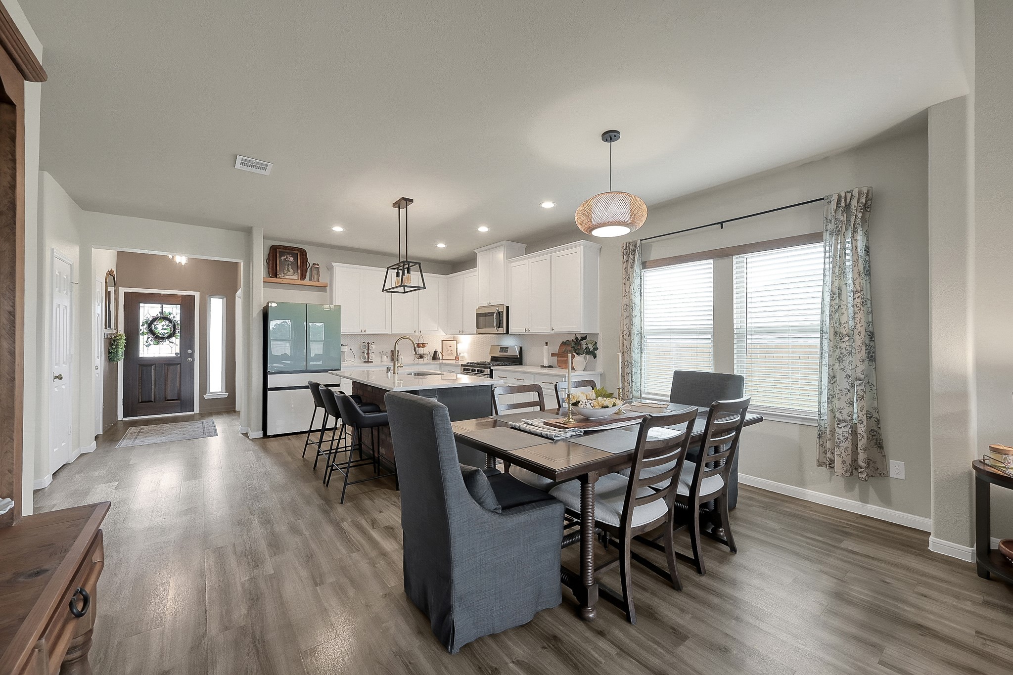 679 Red Elm Lane Conroe, TX 77304 - Photo 14 of 45 a dining room with a wooden table and chairs