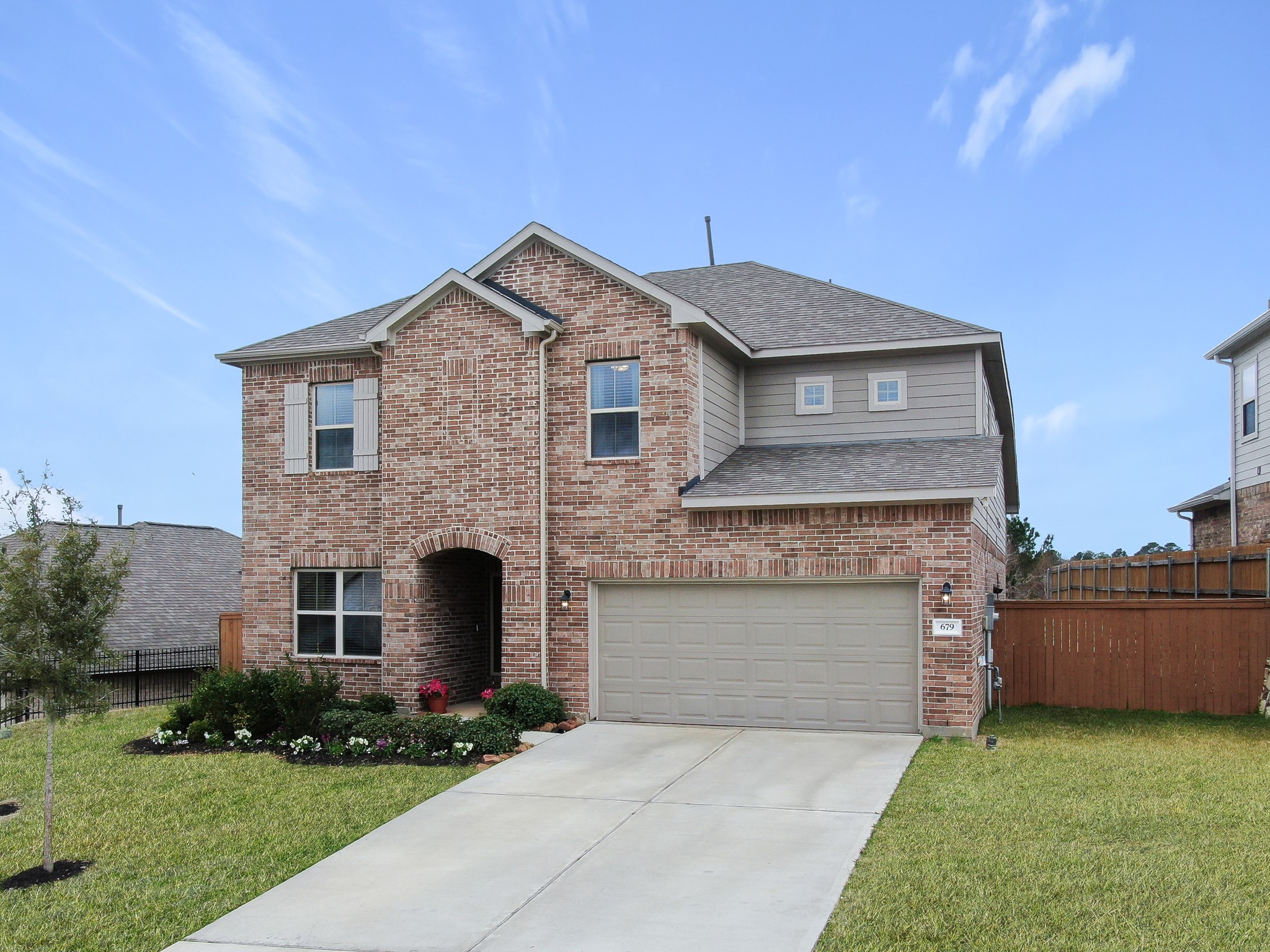 679 Red Elm Lane Conroe, TX 77304 - Photo 2 of 45 a front view of a house with a yard