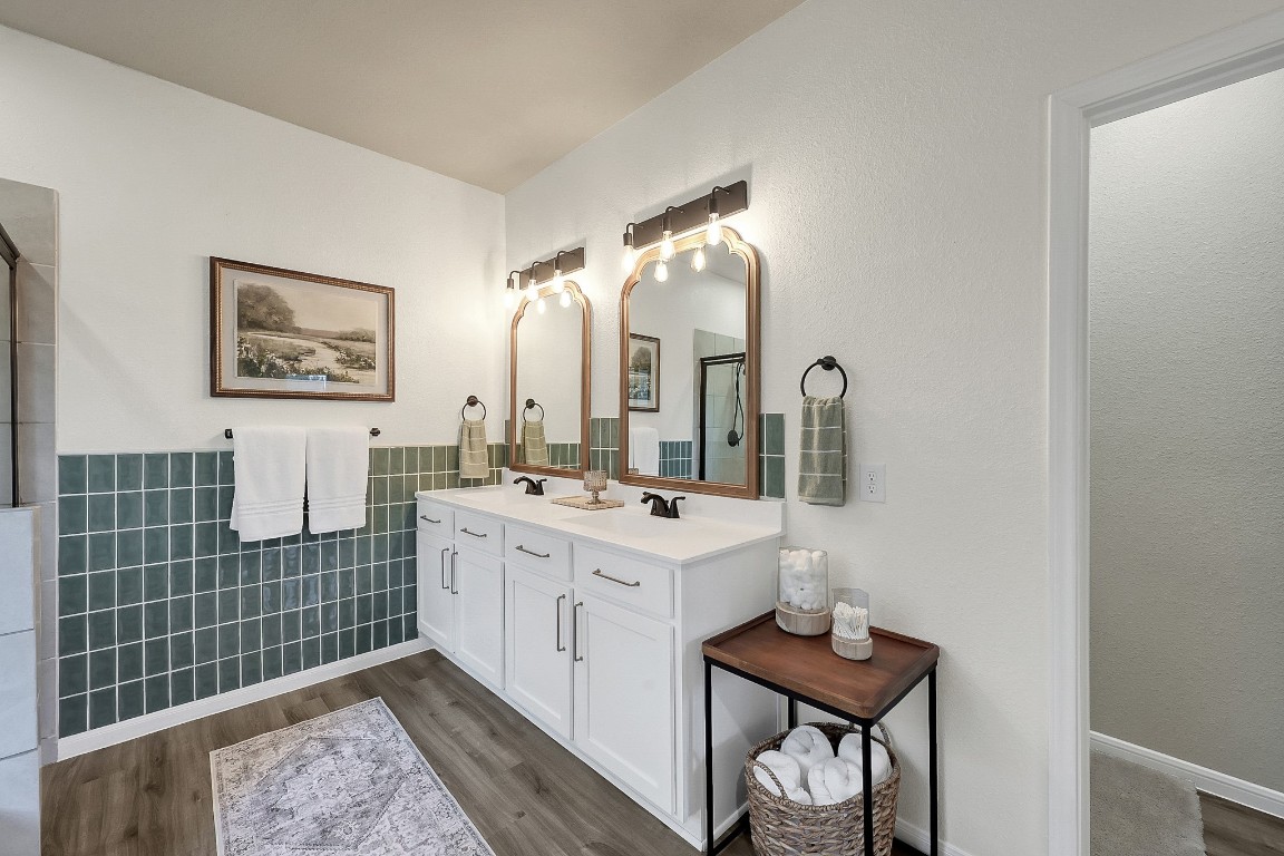 679 Red Elm Lane Conroe, TX 77304 - Photo 25 of 45 a bathroom with a sink a mirror and a shower