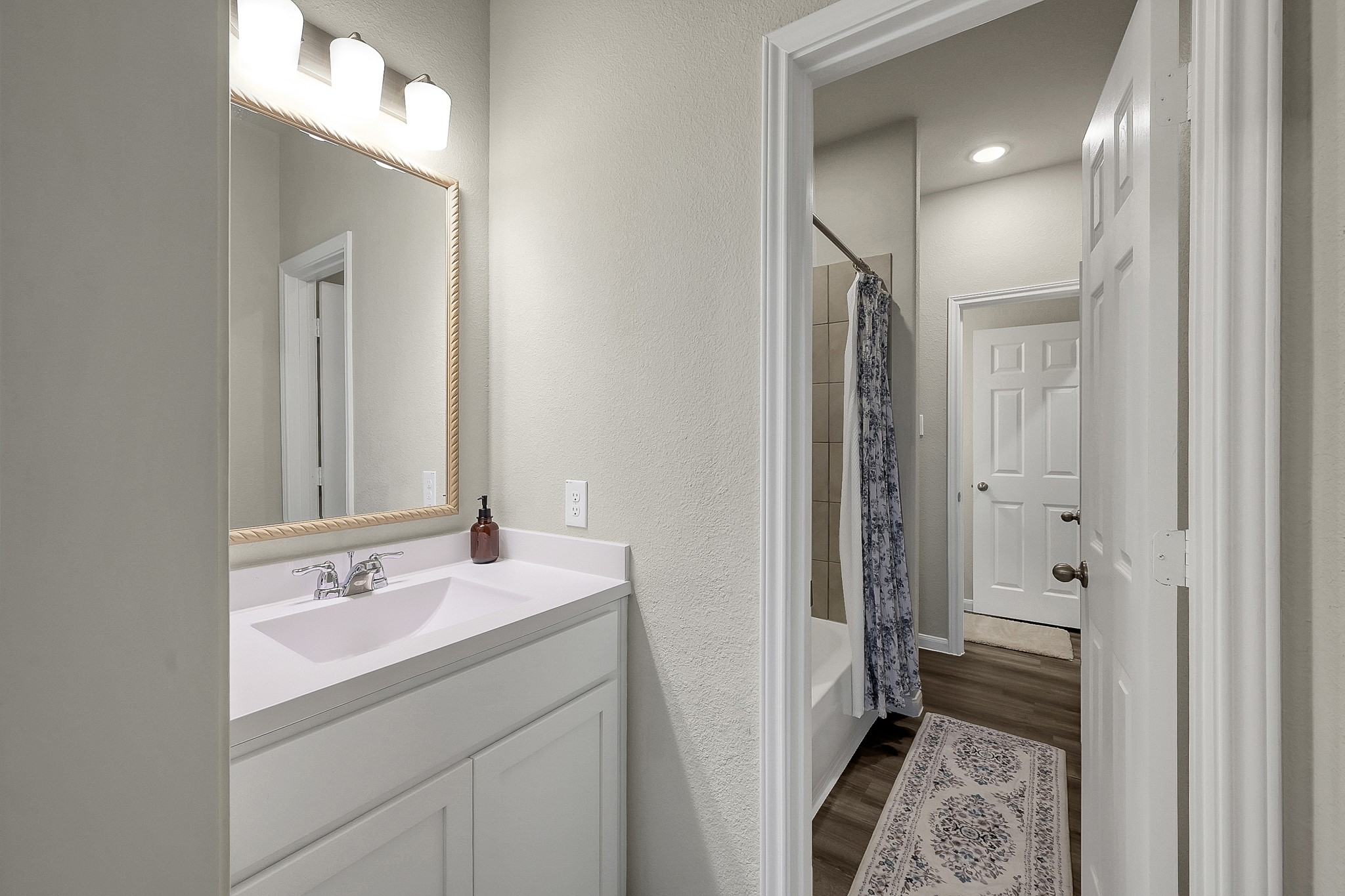 679 Red Elm Lane Conroe, TX 77304 - Photo 30 of 45 a bathroom with a sink a light fixture and a mirror