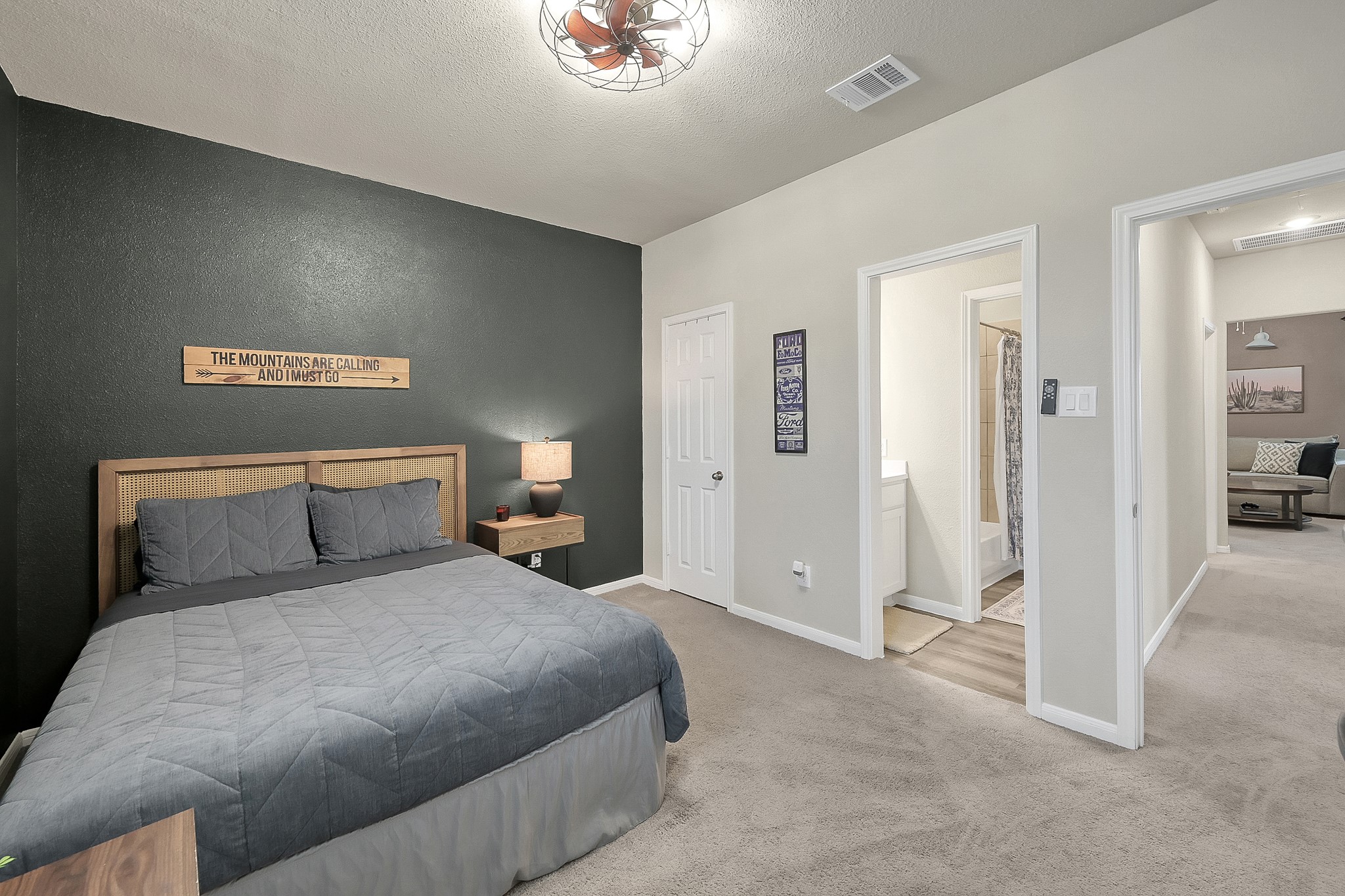 679 Red Elm Lane Conroe, TX 77304 - Photo 31 of 45 a bedroom with a large bed and a chandelier
