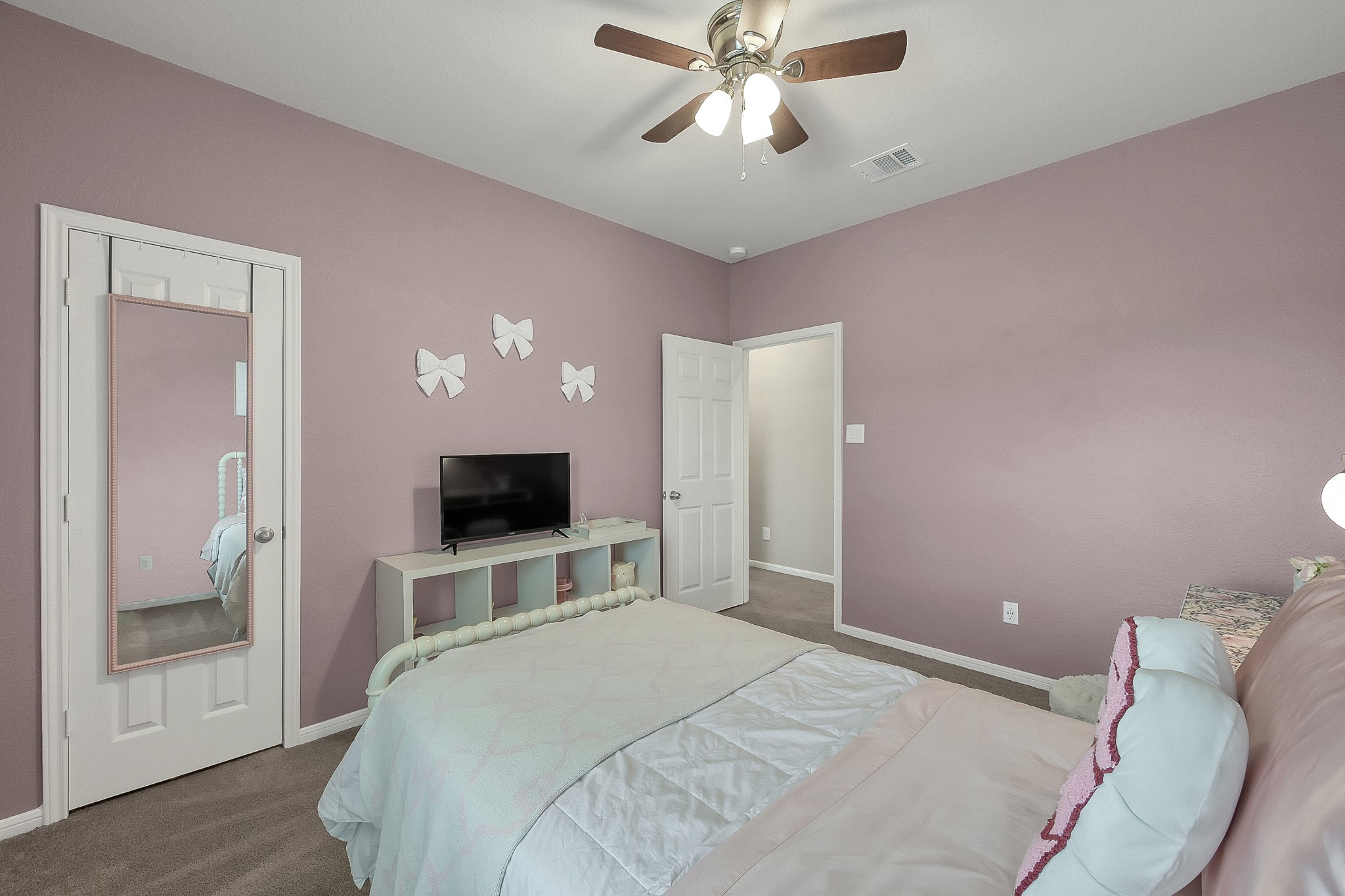 679 Red Elm Lane Conroe, TX 77304 - Photo 34 of 45 a bedroom with a bed and a flat screen tv