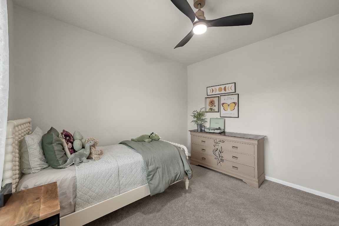 679 Red Elm Lane Conroe, TX 77304 - Photo 36 of 45 a bedroom with a bed and ceiling fan