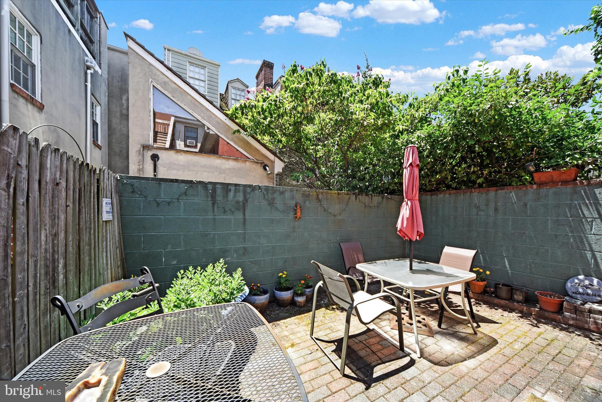 1611 Lancaster Street Baltimore, MD 21231 - Photo 25 of 43 a view of a patio with table and chairs and potted plants