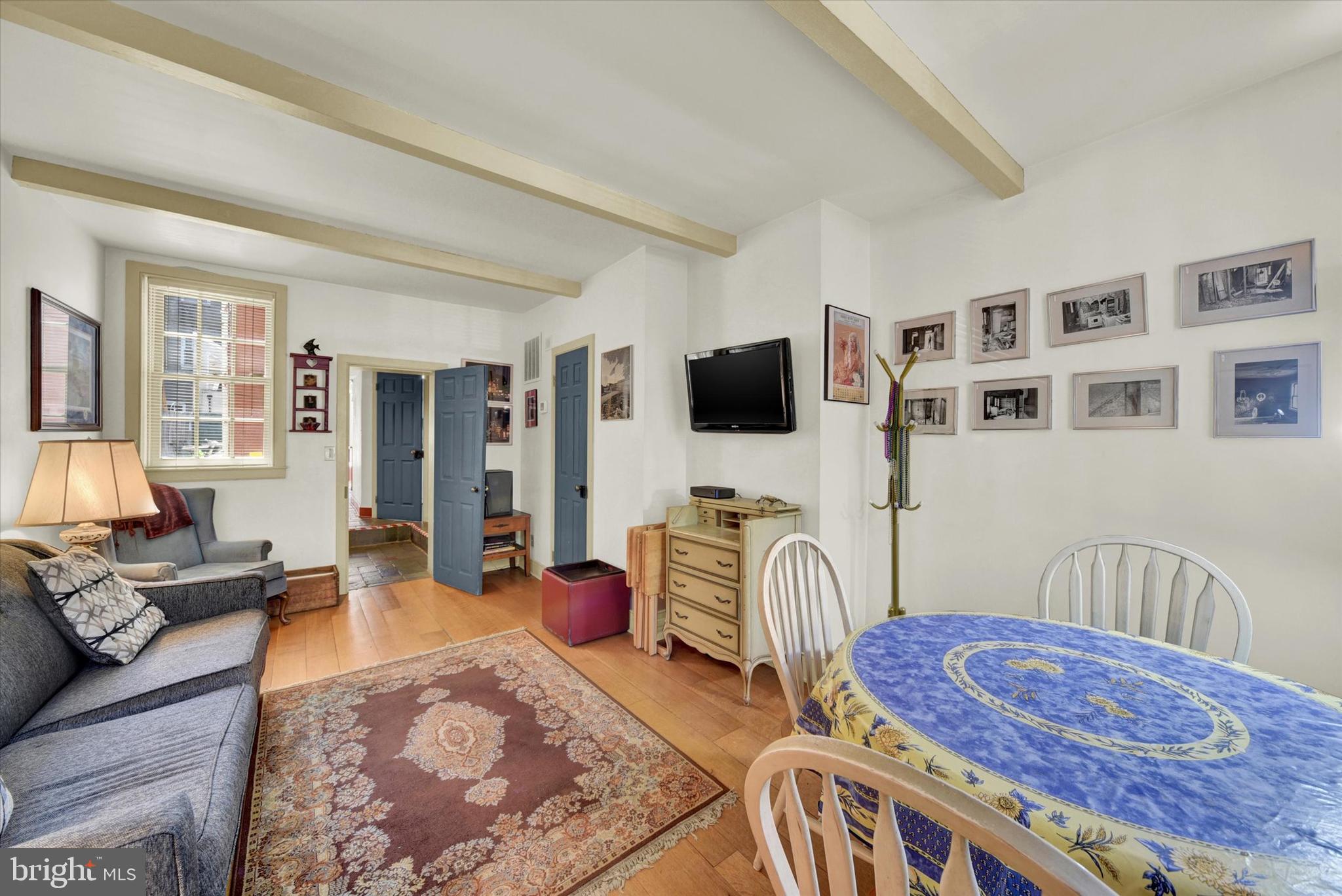 1611 Lancaster Street Baltimore, MD 21231 - Photo 6 of 43 a bedroom with furniture and a flat screen tv