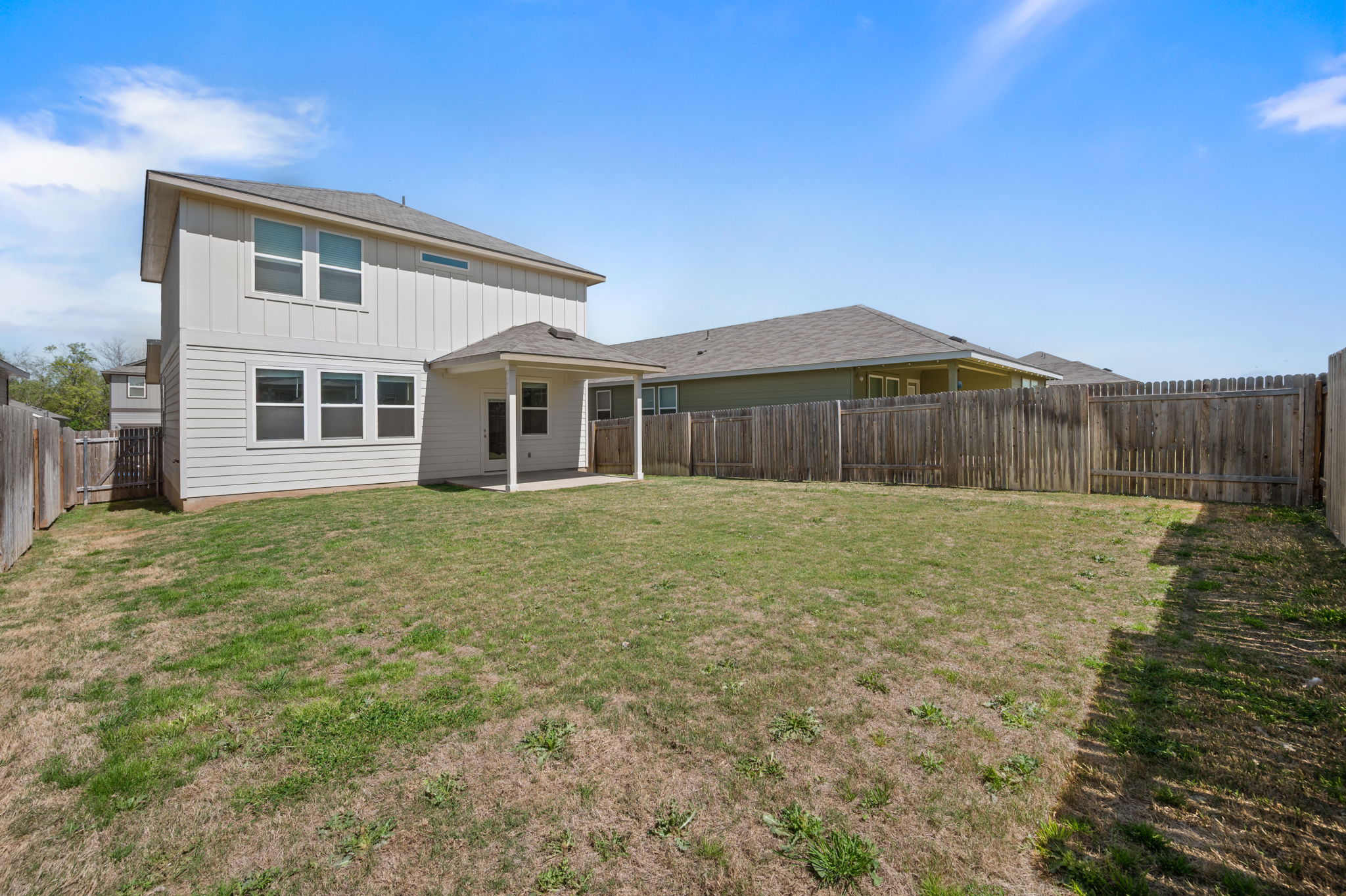 529 View Drive Georgetown, TX 78628 - Photo 20 of 20 Back of property featuring a patio area, a fenced backyard, board and batten siding, and roof with shingles