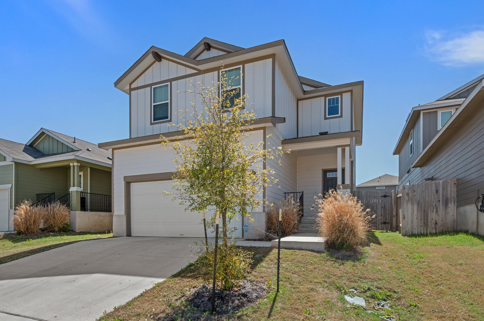 529 View Drive Georgetown, TX 78628 - Photo 2 of 20 View of front of property with a garage, board and batten siding, and concrete driveway
