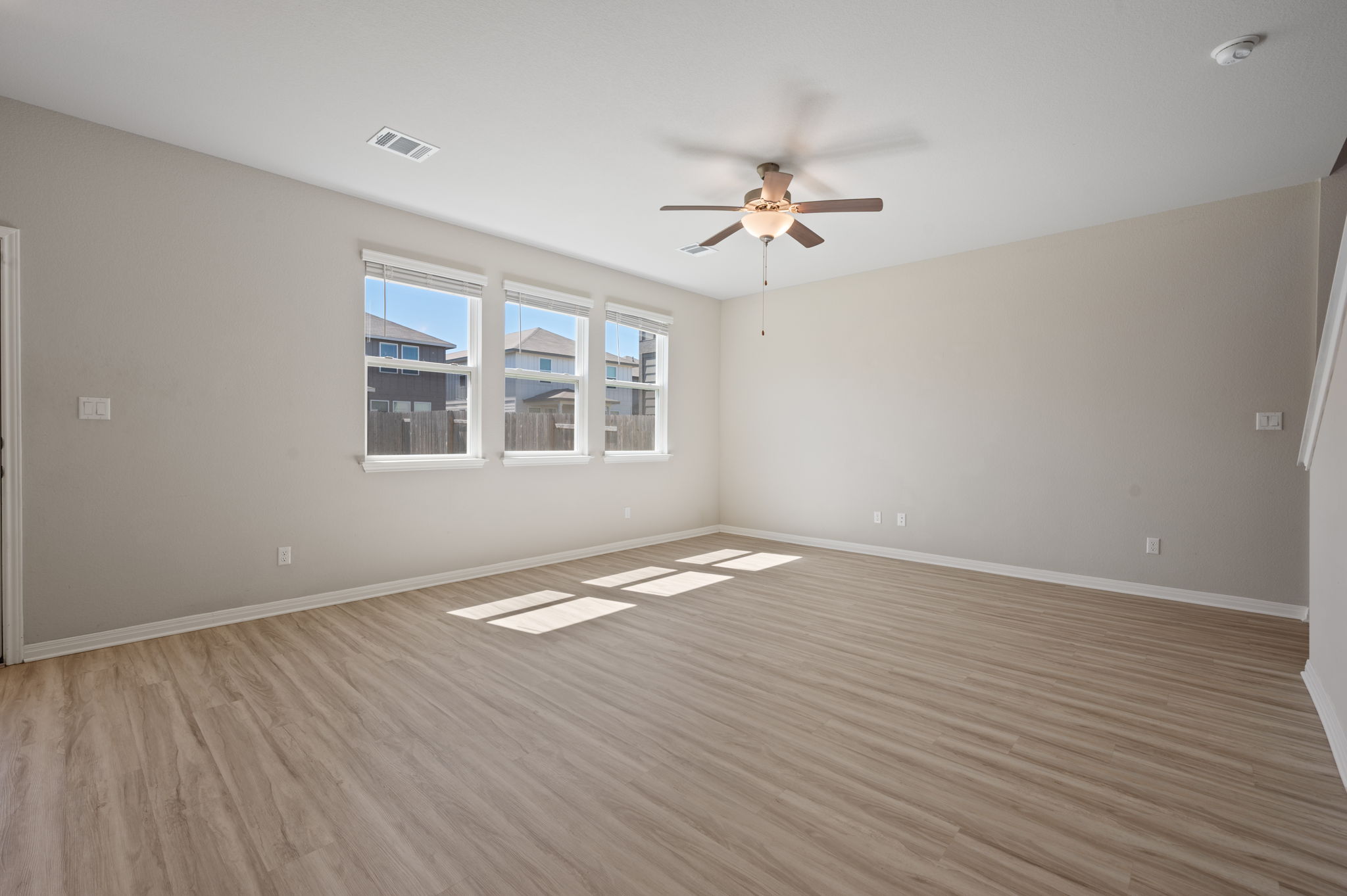 529 View Drive Georgetown, TX 78628 - Photo 4 of 20 Empty room with ceiling fan and light wood-style floors